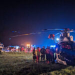Hubschrauber bei Nacht und Rettungskräfte und Rettungswagen